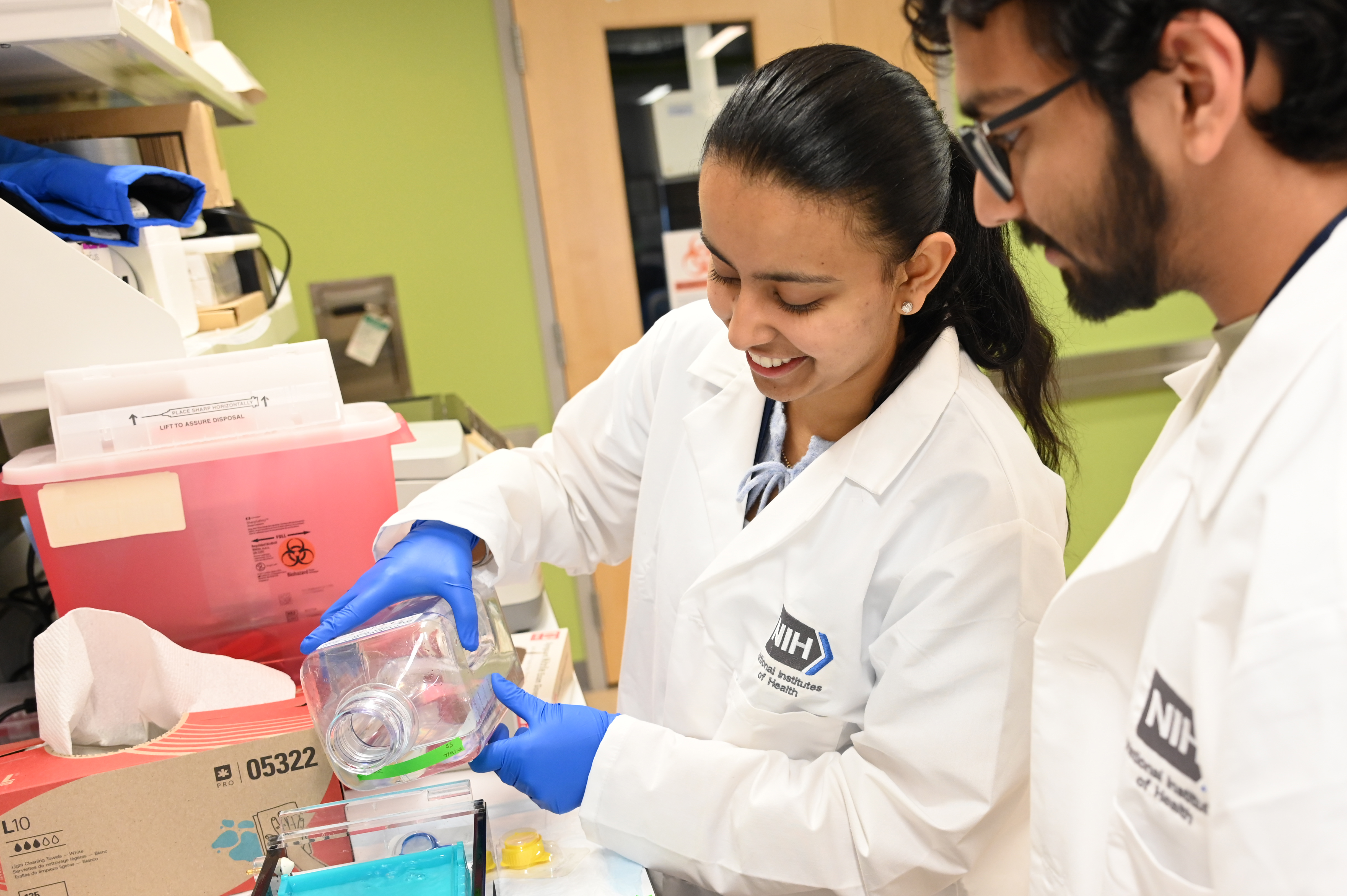 Two fellows conducting research at the bench.