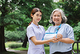 Older woman with broken wrist standing next to female health care provider