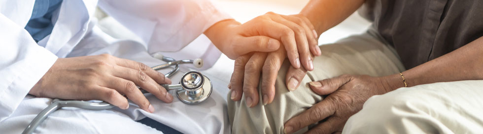 A doctor holding a patient's hand