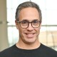 Headshot of a man with short hair in professional attire.