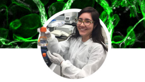 Female student in a lab holding a flask