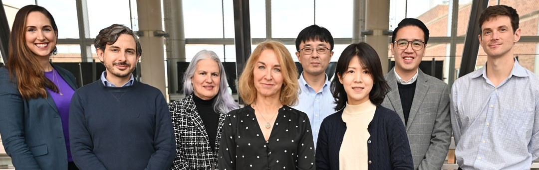 A group of diverse scientists, standing shoulder to shoulder.