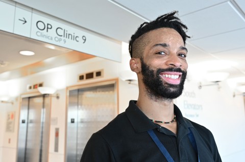 Photo of a young, male trainee, outside a medical clinic