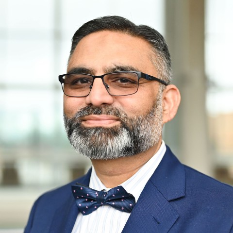 Headshot of a man in a jacket and bow tie.