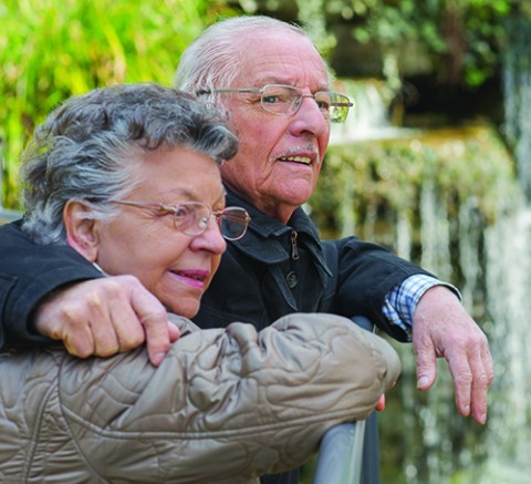 A couple outdoors, hugging each other