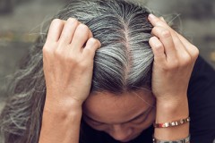 Photo of a woman showing her gray hair.