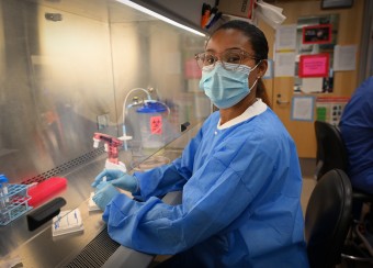 Fellow working in a fume hood.