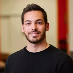 Headshot of young man with short hair and a beard.