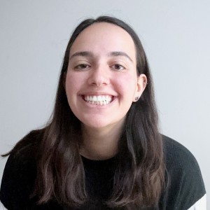 Headshot of a young woman with long hair, smiling.