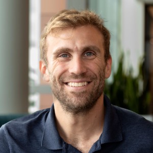 Headshot of a man with short, light hair.