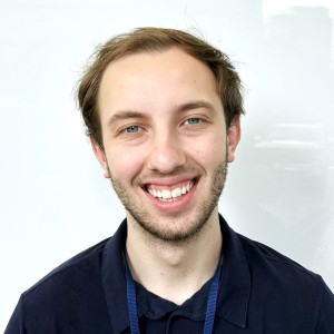 Headshot of a young man, smiling.
