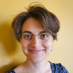 Headshot of a young woman wearing glasses.
