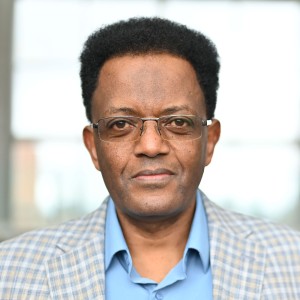 Headshot of a man with shirt hair in a suit.