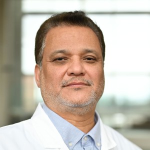 Headshot of a man with short hair in a lab coat.