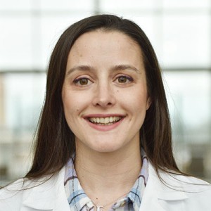 A young female doctor in a lab coat.