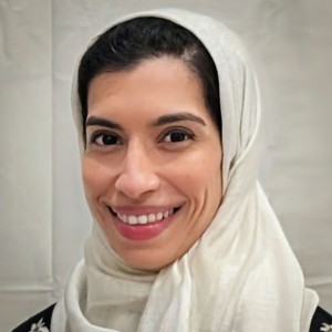 Headshot of a woman wearing a head scarf.