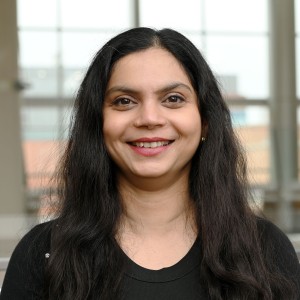 Headshot of a woman with long dark hair in formal attire.