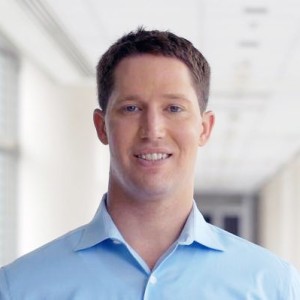 Headshot of a man with short hair, wearing a shirt.