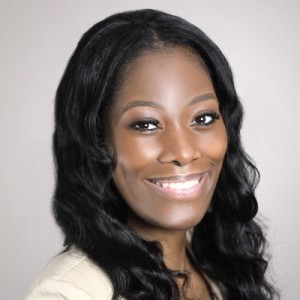 Headshot of a smiling, long-haired woman.