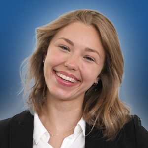 Headshot of a young woman wiuth long hair in business attire