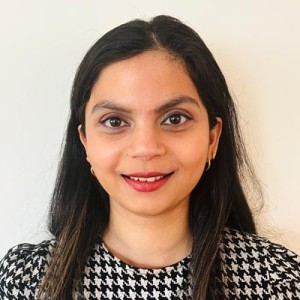 Headshot of a woman with long dark hair in formal attire.
