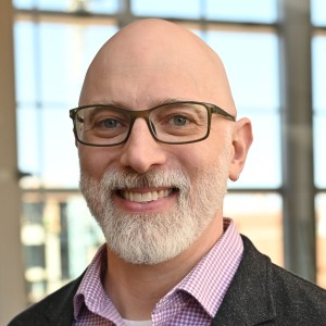 Headshot of a man in business attire.