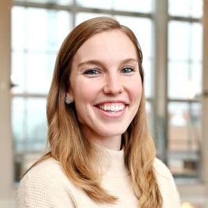 Headshot of a young woman with long hair, smiling