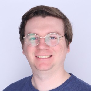 Headshot of a man with short hair, wearing glasses.