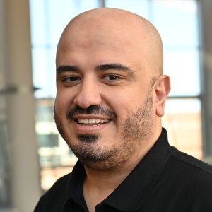 Headshot of a young man in business attire.