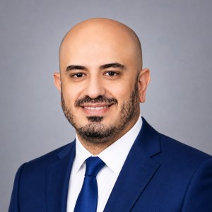 Headshot of a young man in business attire.