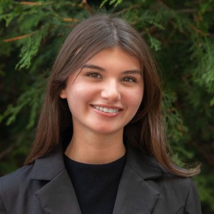 Headshot of a young woman, with long dark hair.