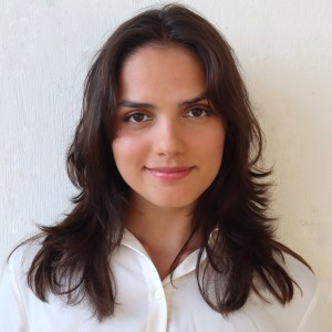 Headshot of a young woman with long dark hair