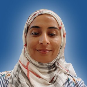 Photo of a young woman in a patterned headscarf.