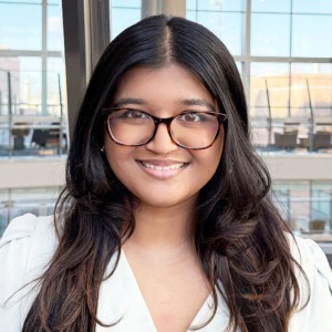 Headshot of a young lady with long hair and glasses.