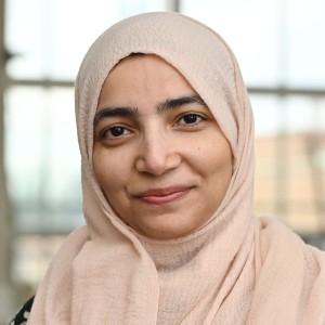 Headshot of a woman wearing a head scarf.