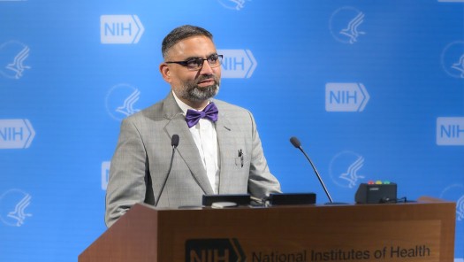 Photo of a man at a lectern.