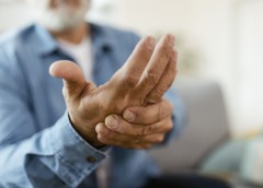 A man holding his hand in pain