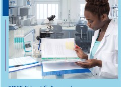 Woman in a research lab looking at papers