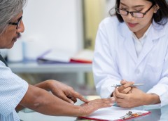 man showing dry skin on his hand to a doctor
