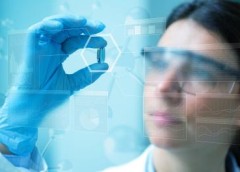 Scientist holding a pill
